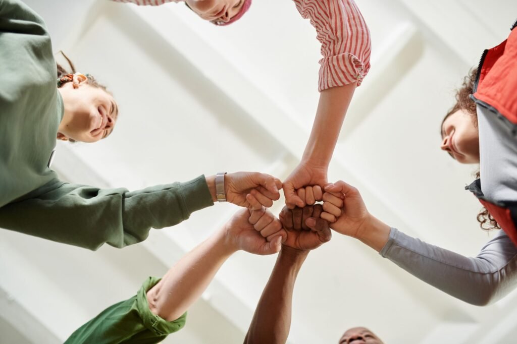 A group of friends sharing laughter highlights the importance of community in fostering hope
