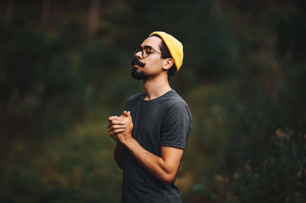A person praying outdoors, seeking God's strength and guidance in their life