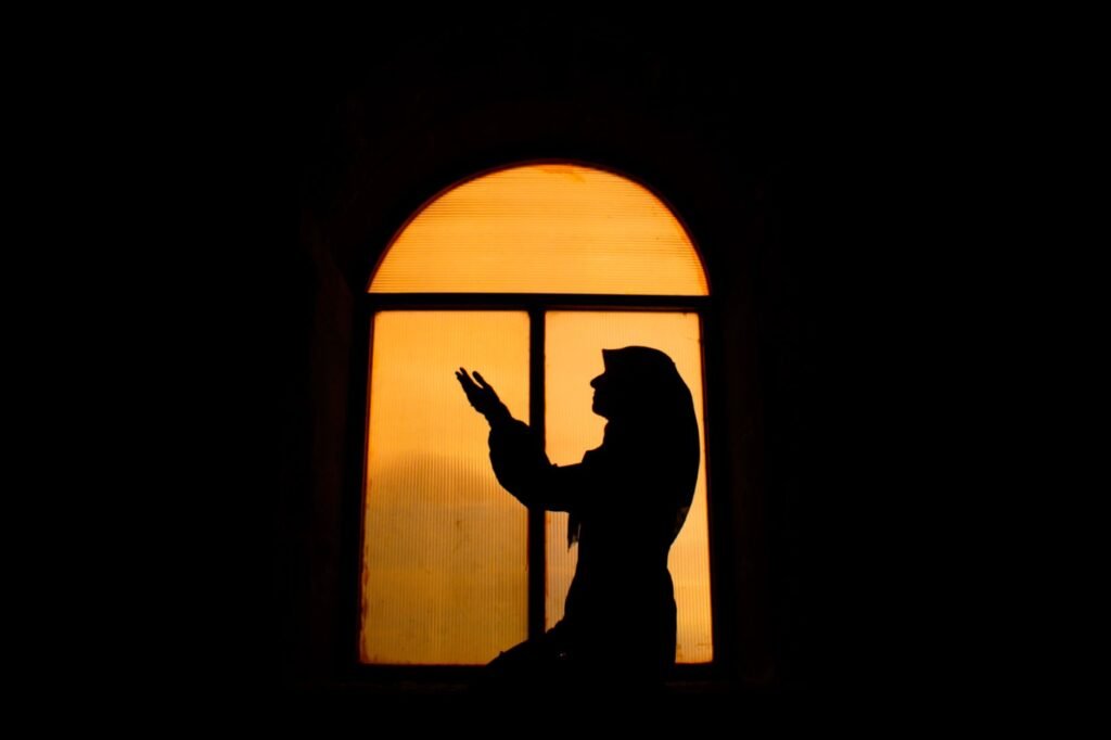 A woman in prayer, seeking solace and strength during a difficult season