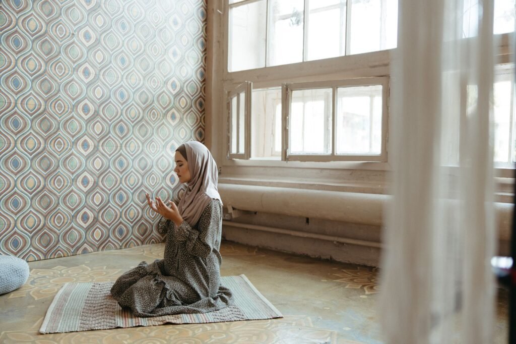 A woman in prayer, seeking strength from God during challenging times