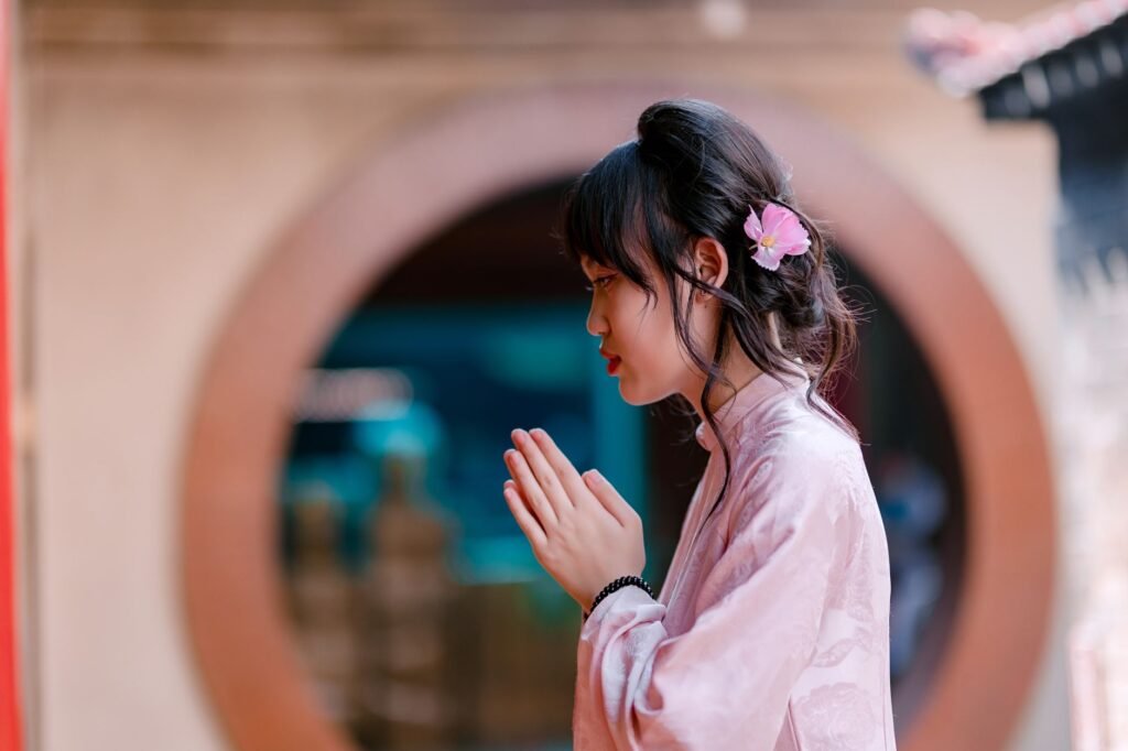 A woman praying by a window illustrates the importance of connecting with God in prayer
